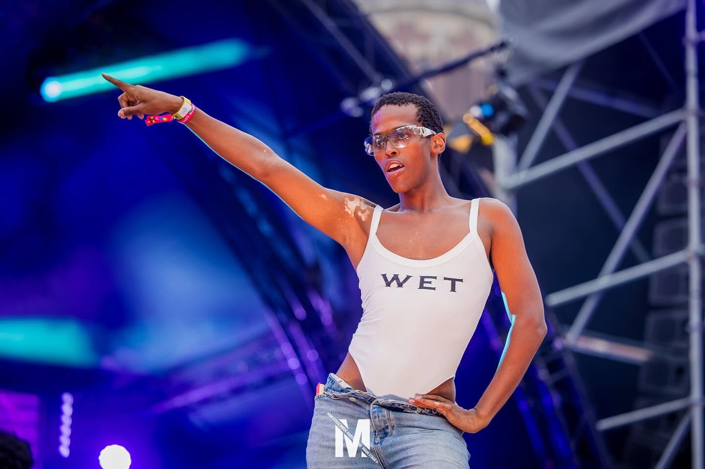 Performer under blue stage light at MainStage Pride on the Dam