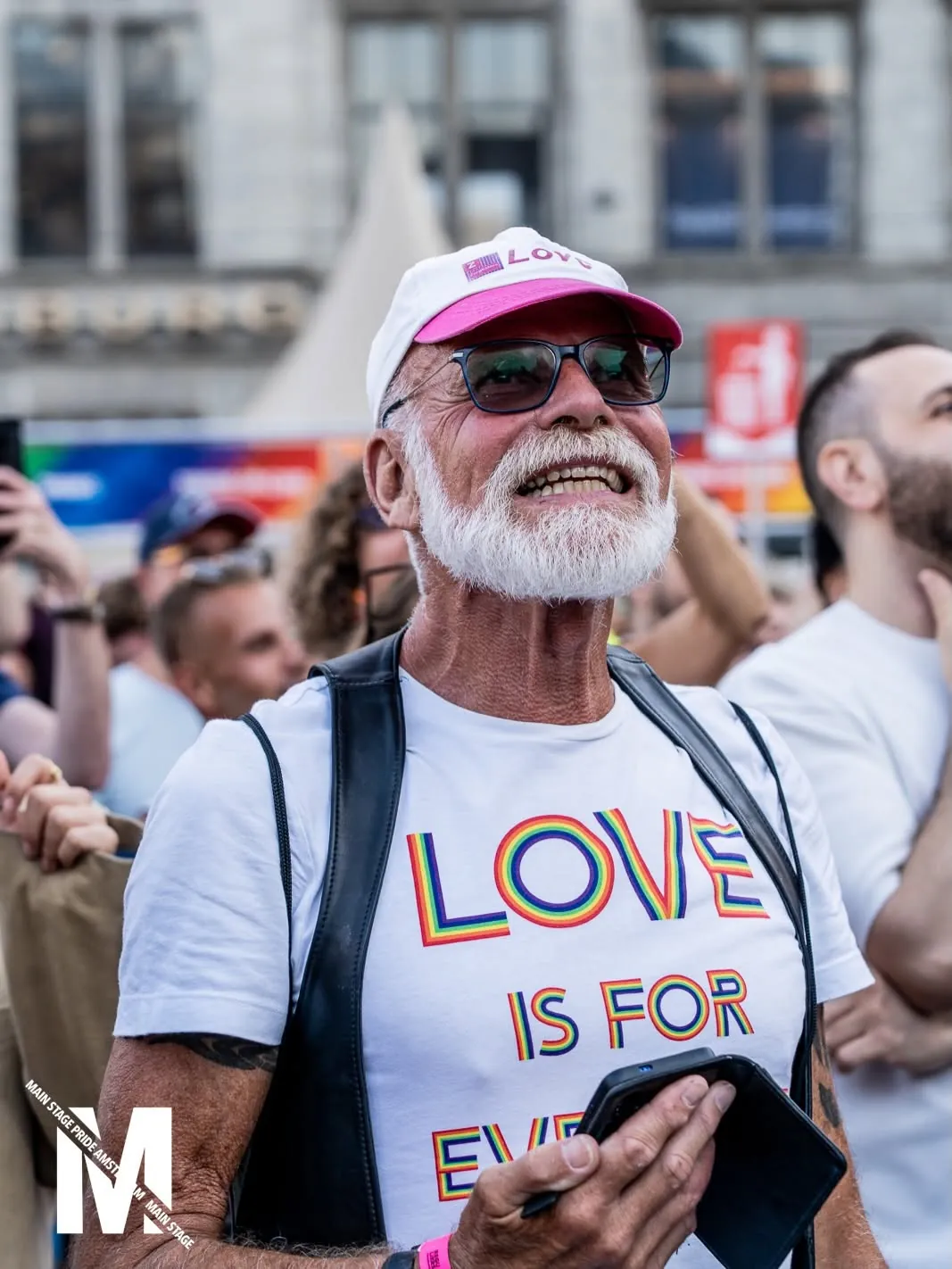 Smiling visitor in a rainbow LOVE shirt in the crowd, MainStage Pride Amsterdam 2026